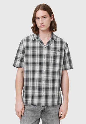 Kurzärmliges kariertes Hemd in Schwarz und Weiß mit einem Camp-Kragen und Knopfverschluss. Material aus Baumwollmischung mit weich angenehmer Textur.