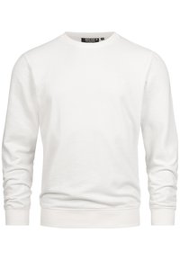 Sweat-shirt blanc en tissu doux, doté d'un col rond, de manches longues et de poignets côtelés. Détail discret du logo sur la poitrine.