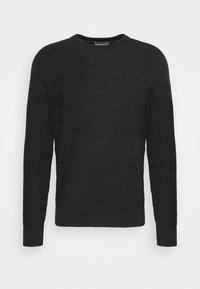 Pullover nero in maglia con un motivo a griglia testurizzato, scollo rotondo e polsini e orlo a costine. Tessuto morbido con una silhouette aderente.