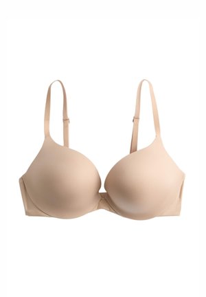 Beige padded bra with adjustable shoulder straps and smooth molded cups, designed for support and comfort.