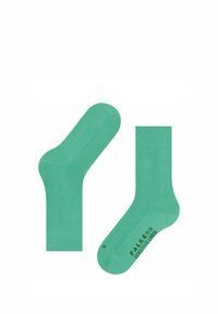 Türkise Socken aus glattem Stoff, mit einem gerippten Bündchen, nahtlosem Zehendesign und bedrucktem Markennamen an der Seite.