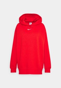 Röd hoodie i mjukt tyg. Har en framfickor i känguru-stil, dragsko för huva och en liten vit Nike-logga på bröstet.