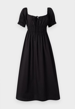 Μαύρο, μίνι φόρεμα μέχρι το γόνατο με κοντά φουσκωτά μανίκια, τετράγωνη λαιμόκοψη και ελαστική ζώνη. Φτιαγμένο από ελαφρύ ύφασμα με λεία υφή.