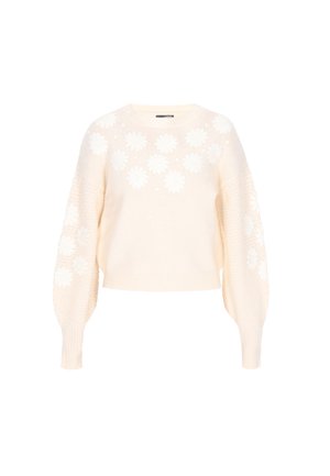 Pull en tricot couleur crème avec des appliqués floraux, des manches ballons et un motif texturé sur les côtés. Design à longueur cropped.