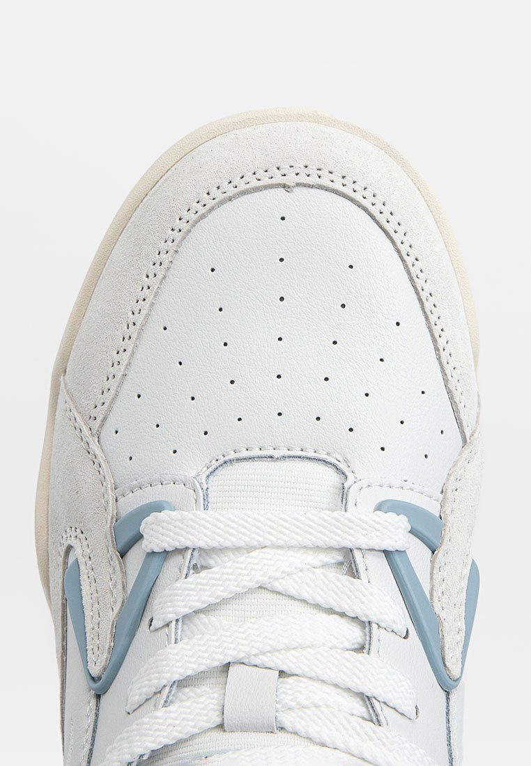 Witte leren sneaker met een gladde afwerking, lichtblauwe accenten, geperforeerde neuskap en platte veters. Beschikt over een rubberen zool met een gestructureerde overlay.