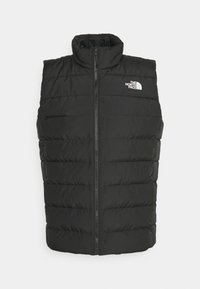 Svart quiltad ärmlös puffer-väst med hög krage, framzipper och vit "The North Face"-logotyp p å bröstet.