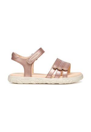 Sandali sintetici color oro rosa con cinturini in Velcro, apertura sul retro e suola in gomma bianca con accenti floreali. Texture liscia, design casual.