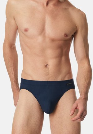 Dunkelblaue Badehose mit gerippter Textur, im Low-Rise-Schnitt und mit einem kleinen Logodetail am Bund.