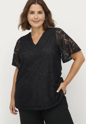 Black lace top with short sleeves and a v-neck design. Features floral patterns and a loose fit that extends slightly below the hips.