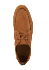 Brown suede shoe with a rounded toe, flat laces, and minimal stitching. The interior is lined with a smooth material.
