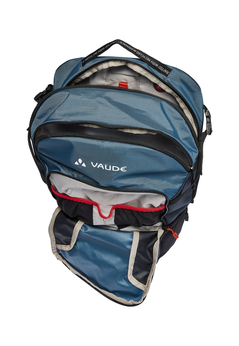 Sac à dos Vaude bleu et noir avec plusieurs compartiments zippés, accents en mesh, détails rouges et une poignée supérieure pour le transport.