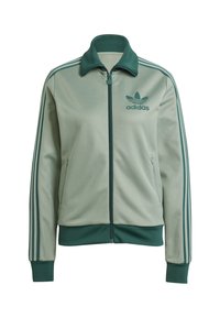 Ljusgrön Adidas träningsjacka med dragkedja, ståkrage och två sidofickor. Har tre mörkgröna ränder på varje ärm.