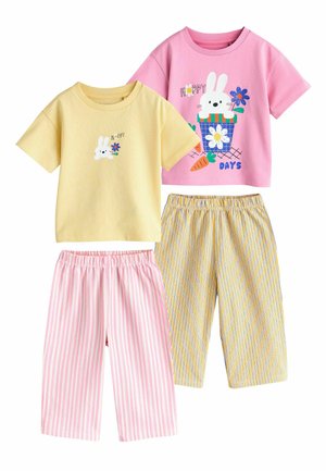 Two sets of children's pajamas: one yellow T-shirt with a bunny and flower, pink striped pants; one pink T-shirt with a bunny, carrot, and flower, yellow striped pants.