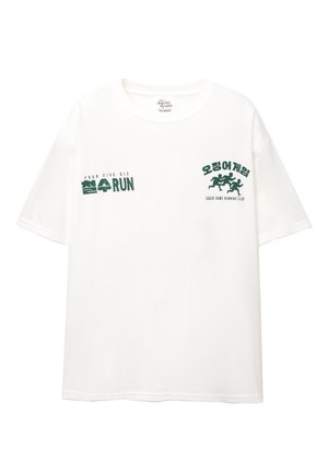 White cotton t-shirt with short sleeves. Green text reads “FOUR FIVE SIX” and “오징어 게임,” along with a graphic of running figures.
