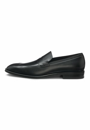 Black leather loafers with a sleek design, rounded toe, and subtle stitching details. Low black heel and smooth texture.