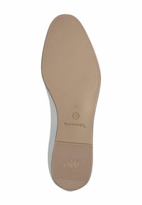 Suola di scarpa realizzata in un materiale gommoso di colore marrone chiaro, con superficie liscia, forma arrotondata e modelli di grip testurizzati, contrassegnata da un brand.