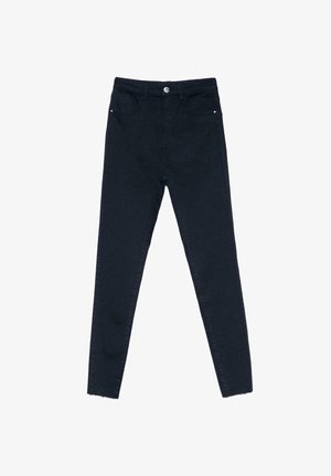 Jean skinny noir taille haute avec fermeture à boutons, poches avant et coutures minimales, posé à plat sur un fond blanc.