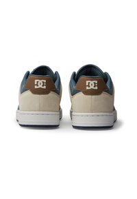 Beige suede sneakers with blue fabric accents, brown heel tab, and white rubber soles. Features logo on the back. Classic low-top design.