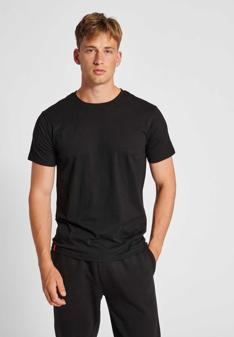 Black cotton t-shirt with a round neck and short sleeves, features a straight fit and minimalistic design without patterns or graphics.