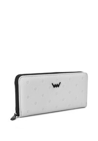 White zippered wallet featuring embossed dot texture, black logo accent, and black zipper trim. Smooth synthetic material.