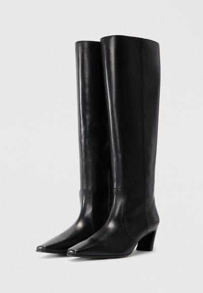 Black knee-high boots made of smooth leather, featuring a pointed toe and a moderate heel. The design is sleek with minimal hardware.