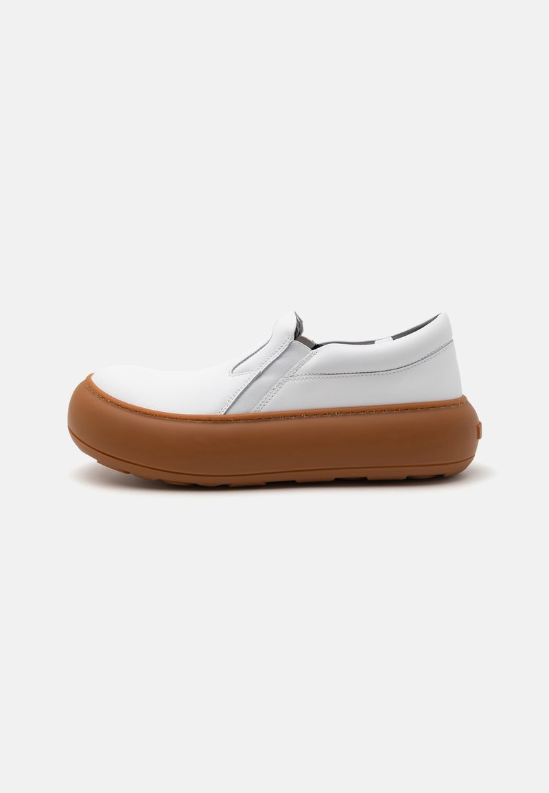 White slip-on shoe with a rounded shape and textured brown rubber sole. Features smooth leather-like upper and minimal design accents.