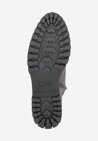 Semelle de botte en suède gris avec un motif de profondeur de sculpture. Présente des rainures en zigzag pour une meilleure traction et un petit logo. Matériau en caoutchouc durable.