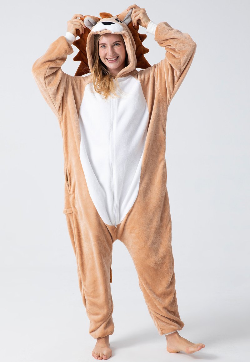 Tan plush lion onesie with white belly and hood, featuring lion ears and mane detail. Zipper closure and side pockets included.