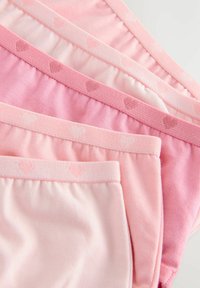 Pack of four pink cotton panties with varying shades. Features elastic waistbands with heart patterns and soft, smooth textures.