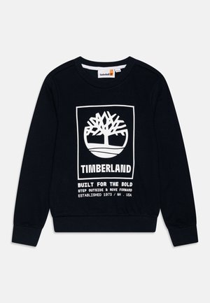 Sweatshirt bleu marine en coton avec un logo d'arbre blanc et du texte. Poignets et ourlet côtelés avec un col ras du cou.