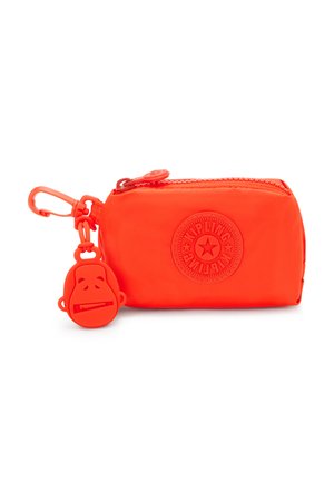 Small orange zippered pouch made of smooth material, featuring a raised logo and a monkey-shaped zipper pull for easy gripping.
