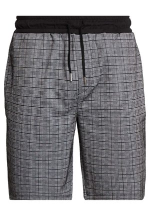 Mustavalkoruudulliset shortsit, joissa on musta joustava vyötärönauha ja musta kiristysnauha hopeisilla päillä.