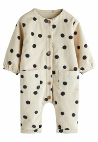 Beige corduroy overall met zwarte stippen, ronde kraag, knoopsluiting, twee voorzakken en elastische manchetten bij de mouwen en ankels.