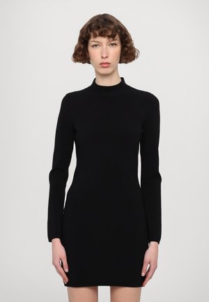 Black long-sleeve dress with a high neckline, made from a smooth, stretchy material. Fitted design with a mini length.