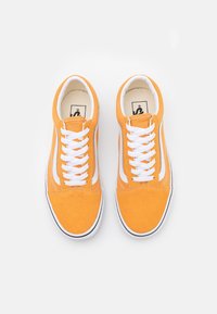 Orange suede sneakers with white laces and side stripes, featuring a flat sole and rounded toe. Simple design, no visible patterns.
