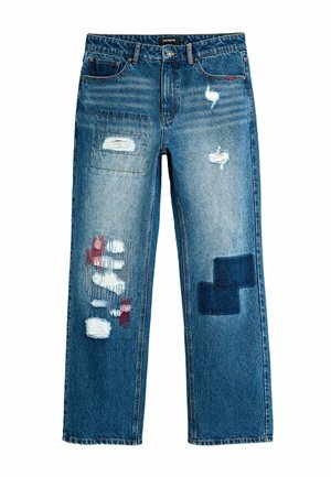 Blue denim jeans with distressed patches, red and white thread details on left leg, and dark square patch on right leg, straight cut style.