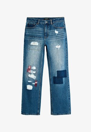 Blue denim jeans with distressed patches, red and white thread details on left leg, and dark square patch on right leg, straight cut style.
