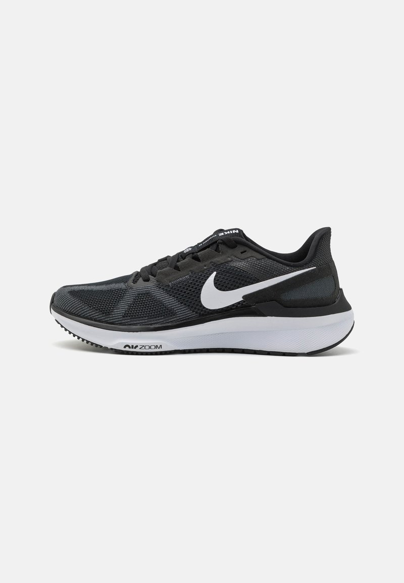 Black athletic sneakers with a mesh upper, white swoosh logo, padded collar, and a thick white and black sole design.
