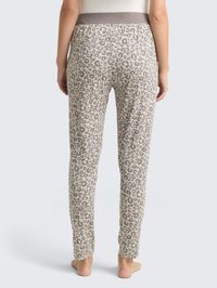 Housut, joissa on leopardikuosi beigeinä ja vaaleanruskeina, pehmeällä ja joustavalla vyötäröltä, sekä kapeahkot lahkeet mukavan istuvuuden saavuttamiseksi.