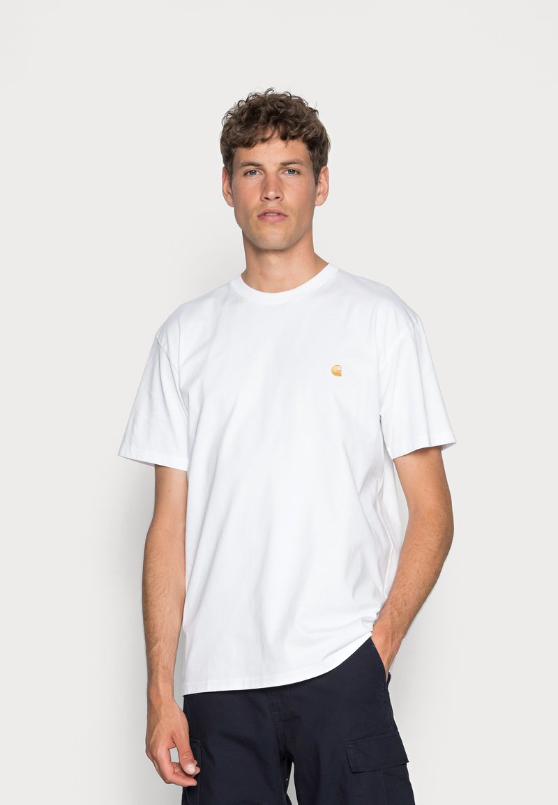 White cotton t-shirt with short sleeves, round neckline, featuring a small yellow logo on the chest. Classic fit, smooth texture.