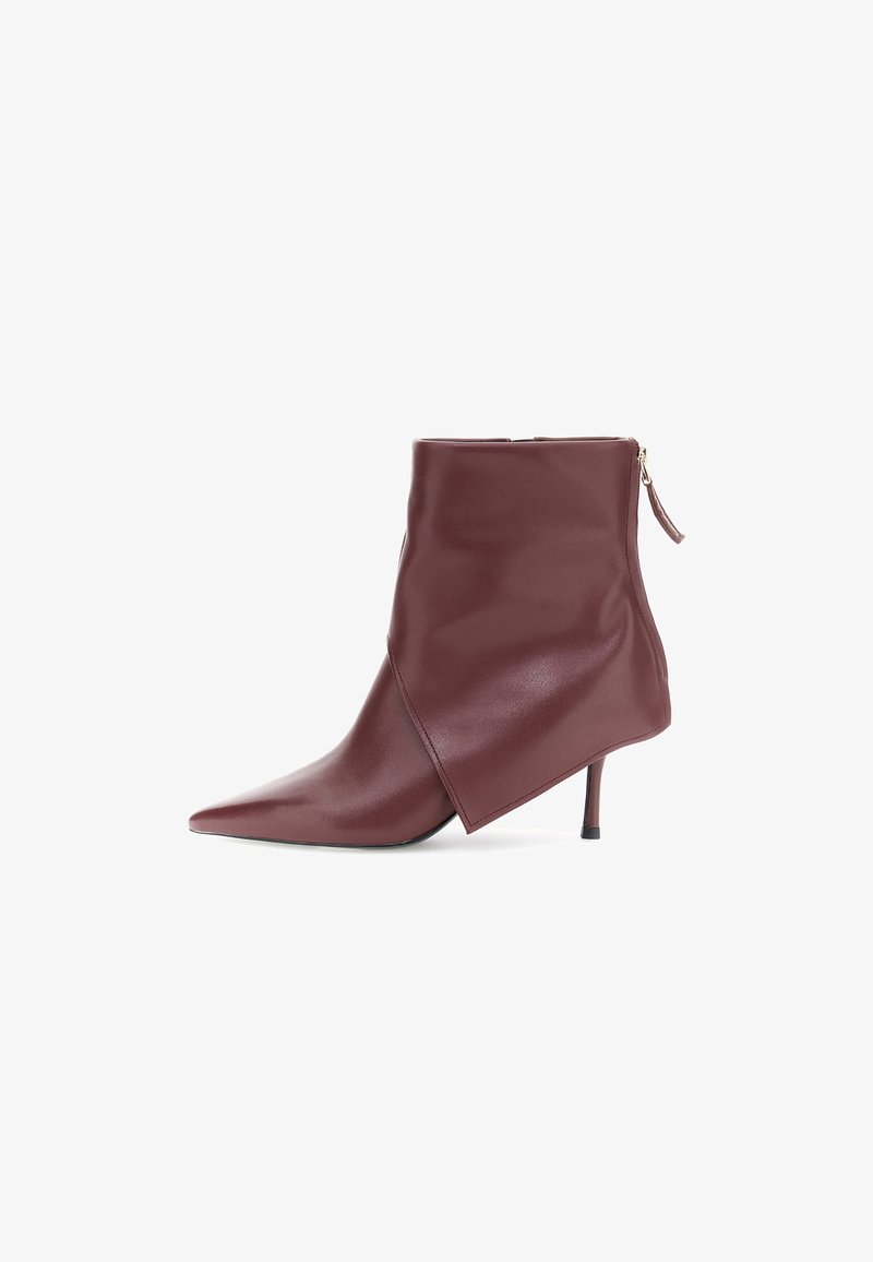 Burgundy leather ankle boot with a pointed toe, asymmetrical design, and a slim stiletto heel. Features a side zipper closure.