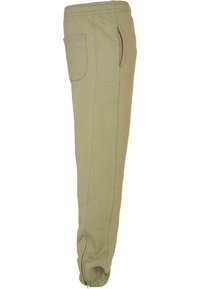Olive green jogger pants made of soft fabric, featuring an elastic waistband, side pockets, and fitted cuffs at the ankles.