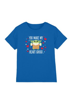 Blue T-shirt with a cartoon green character wearing a brown robe, surrounded by red hearts and white sparkles, with text "You make my heart Grogu."