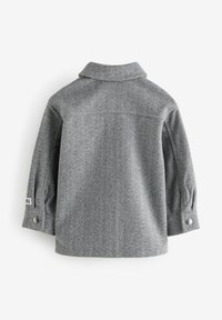 Gray herringbone-patterned long-sleeve jacket with a folded collar and snap buttons on the cuffs shown from the back.