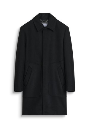 Cappotto di lana nera con colletto alto, tasche frontali e forma rettangolare. Presenta linee pulite e una finitura texturizzata.