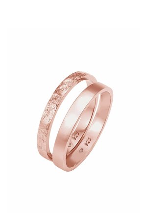 To sammenflettede ringe i rosaguldfinish, den ene med en glat overflade og den anden med en tekstureret overflade, begge stemplet med "925".