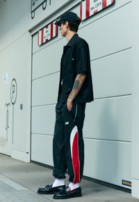 New Balance IN GAME - Pantalon de survêtement - black