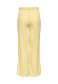 Pantalon jaune clair à jambes larges avec taille élastique, vu de dos sur fond blanc.