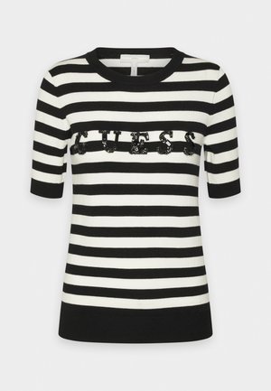 Top manches courtes rayé horizontalement noir et blanc, col rond et logo « GUESS » en sequins noirs sur la poitrine.
