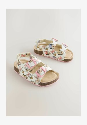 Bijele sandale s šarenim printom crtanih likova, dvije ružičaste podesive trake, pregača boje kože i teksturirana ružičasta gumena potplata.